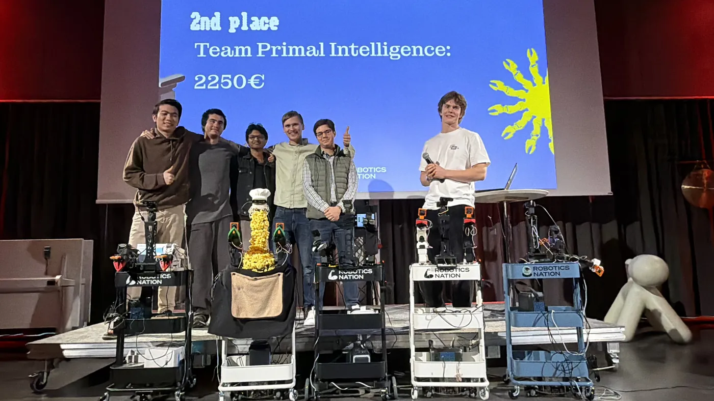 Primal Intelligence on stage in front of the second place slide